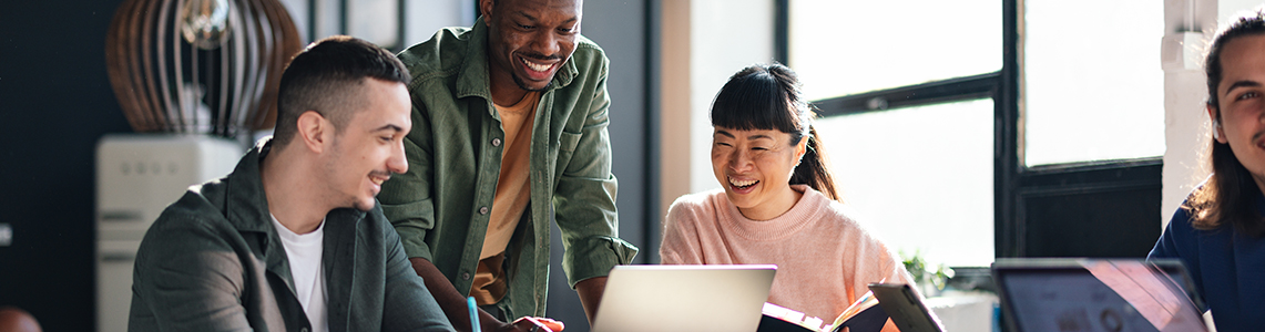 A group of colleagues stood around a table