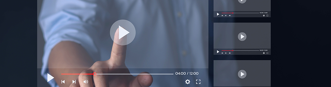 A person pressing the play button on a touch screen