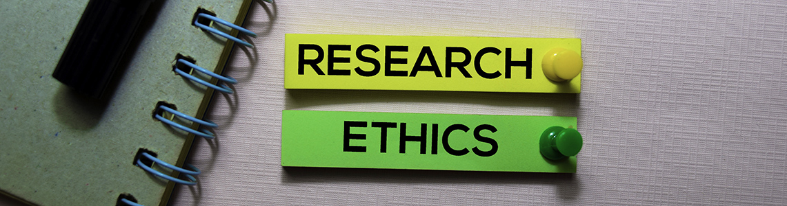 The words research ethics written on post-it notes and pinned to a notice board