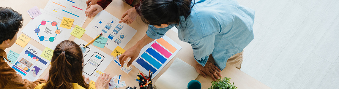 People stood around a table with papers on it