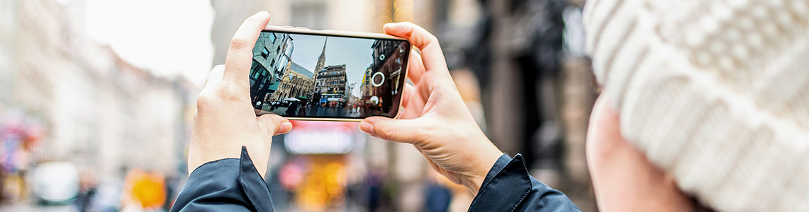 A person taking a photo of a street on a phone
