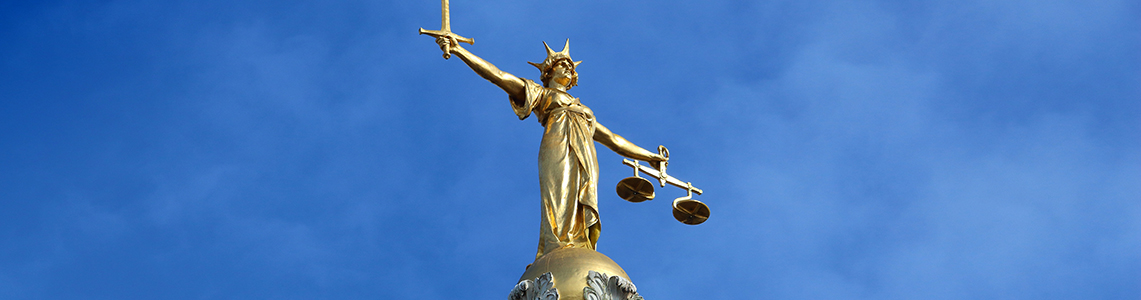 The statue on top of the Central Criminal Court in London, UK.